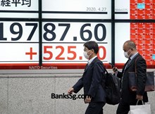 BOJ expands stimulus, cuts growth forecast